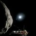 a model comet with a robotic spacecraft floating beside it and a bright light above